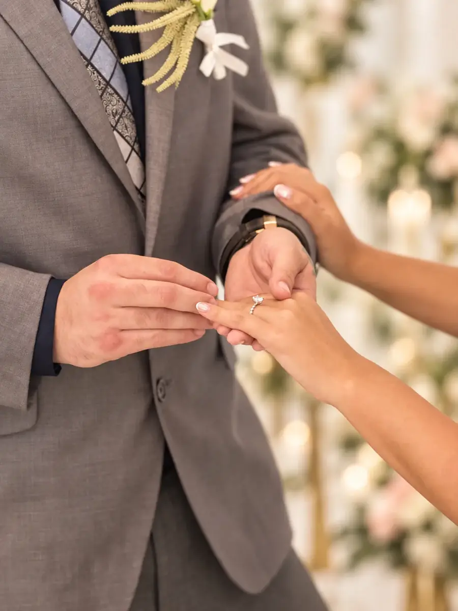 Groom placing a wedding ring during the ceremony