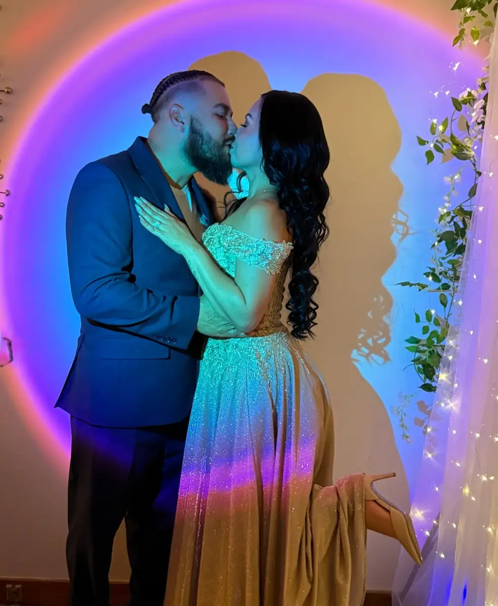 Couple kissing in a colorful wedding portrait